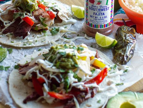 Southwest fajita steak tacos with grilled peppers, guacamole, and Fiesta Brand Southwest Style Fajita Seasoning