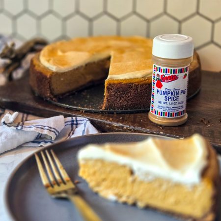 Slice of Pumpkin Cheesecake with small jar of Bolner's Fiesta Brand Pumpkin Pie Spice, 1.5 ounces