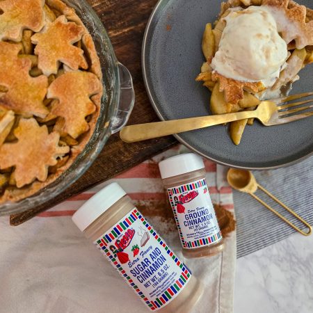 Apple pie with lattice crust topped with a scoop of Ice cream and cinnamon, alongside Bolner’s Fiesta Brand Sugar and Cinnamon